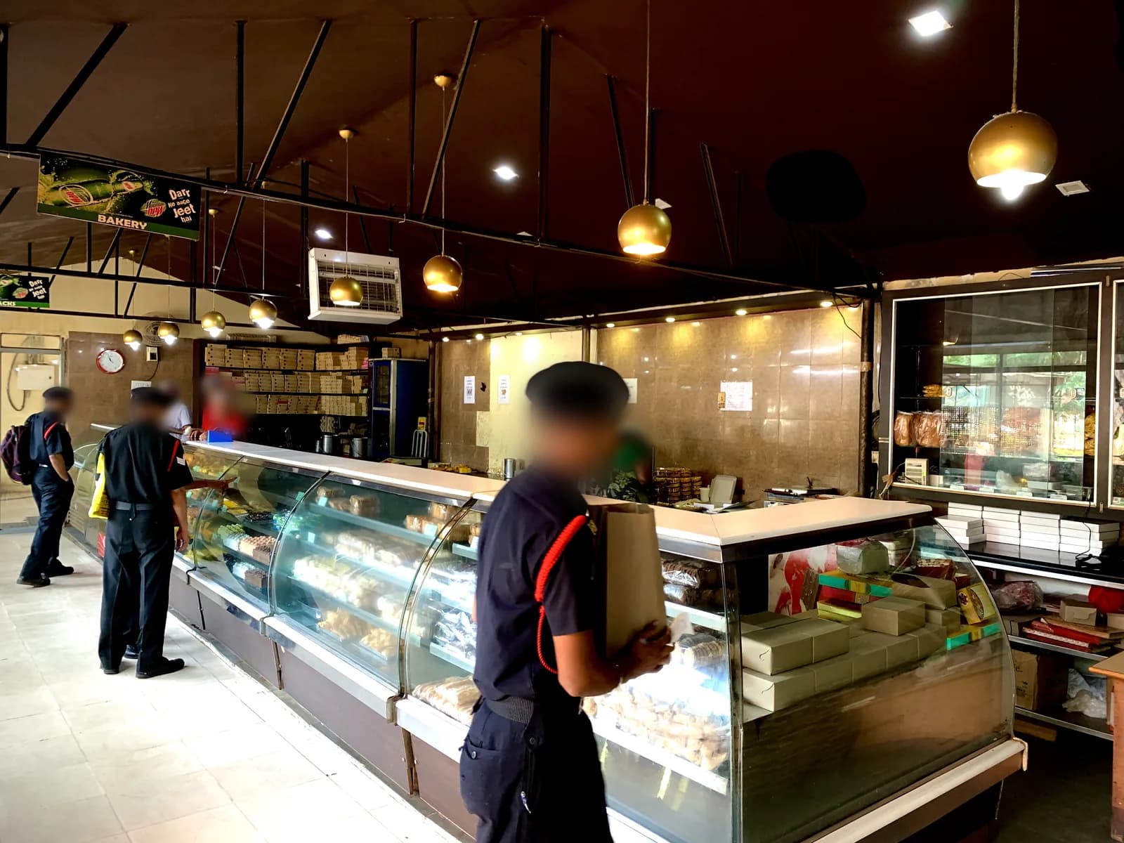 Our store inside the ASC Centre, Bengaluru: a long sweet counter with jawans buying boxes